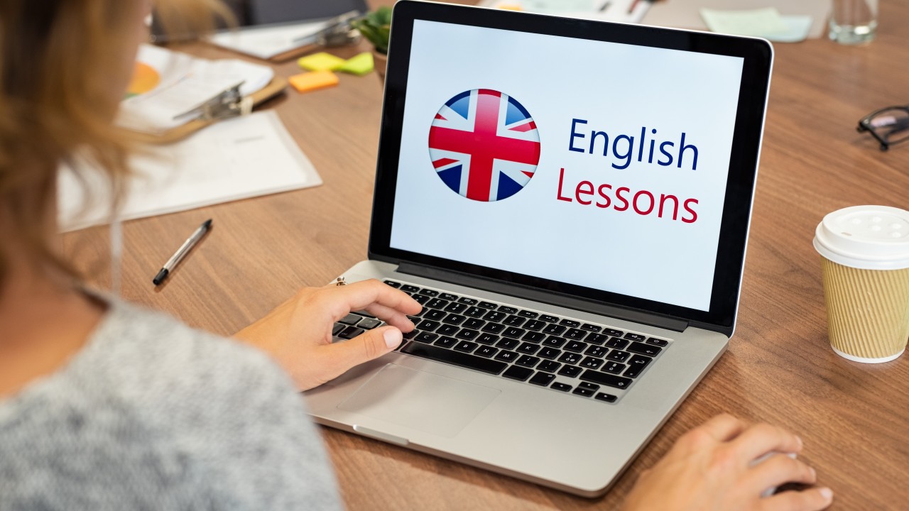 inglés. Una persona mirando la pantalla de un portátil con el texto "English lessons"